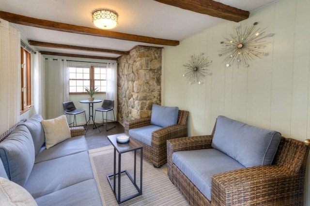 living area featuring beam ceiling