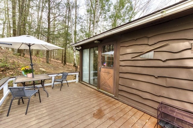 wooden deck featuring outdoor dining space