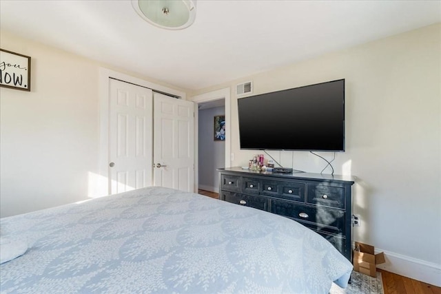 bedroom featuring wood-type flooring and a closet