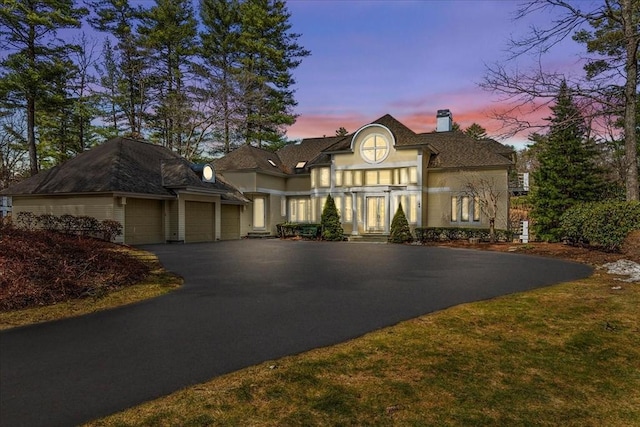 44 Southpoint Ln, Ipswich, MA 01938 - view of front of property featuring a chimney, driveway, and an attached garage