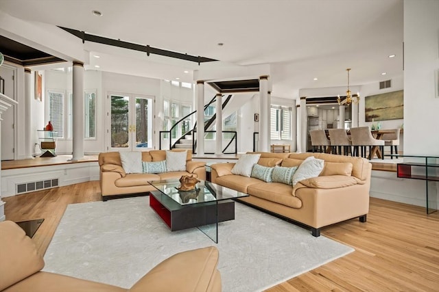 44 Southpoint Ln, Ipswich, MA 01938 - living room with wood finished floors, stairs, a chandelier, ornate columns, and recessed lighting