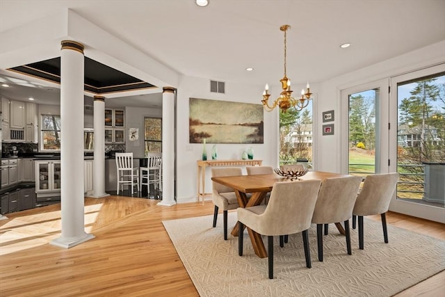 44 Southpoint Ln, Ipswich, MA 01938 - dining space with ornate columns, plenty of natural light, a chandelier, recessed lighting, and light wood-style flooring