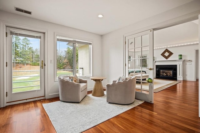 44 Southpoint Ln, Ipswich, MA 01938 - living room featuring wood finished floors, a glass covered fireplace, and recessed lighting