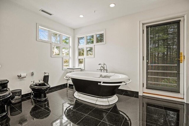 44 Southpoint Ln, Ipswich, MA 01938 - bathroom with granite floors, a freestanding tub, recessed lighting, and a bidet