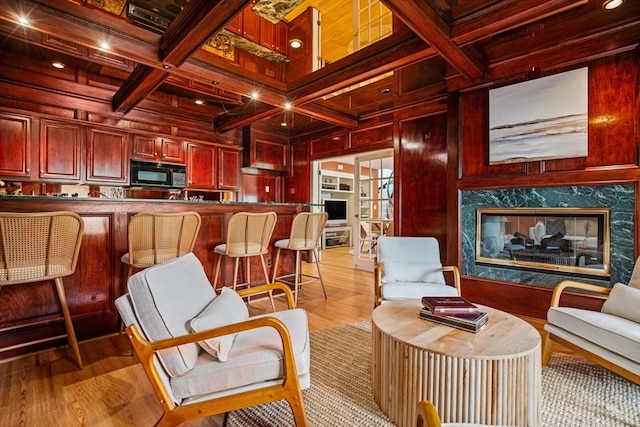 44 Southpoint Ln, Ipswich, MA 01938 - living area with wooden walls, beamed ceiling, coffered ceiling, and light wood finished floors