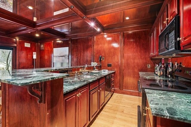44 Southpoint Ln, Ipswich, MA 01938 - kitchen featuring black appliances, reddish brown cabinets, dark stone counters, light wood finished floors, and wood walls