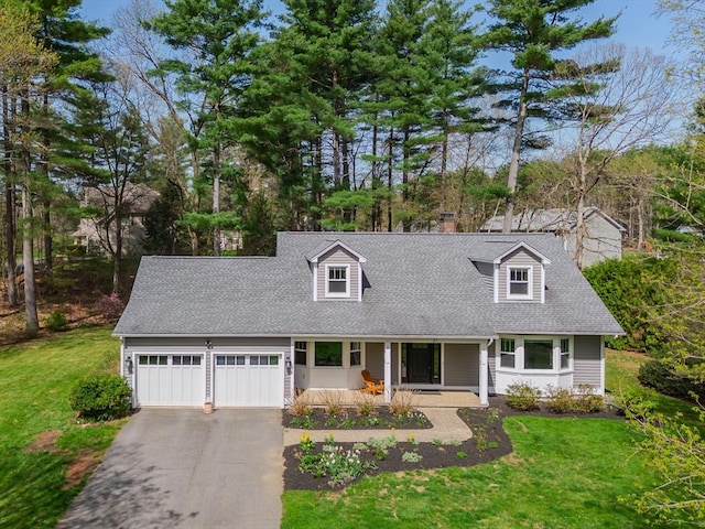 cape cod house with an attached garage, a front lawn, aphalt driveway, and covered porch