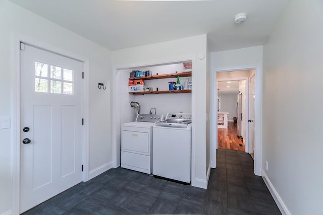 laundry room featuring separate washer and dryer, laundry area, and baseboards