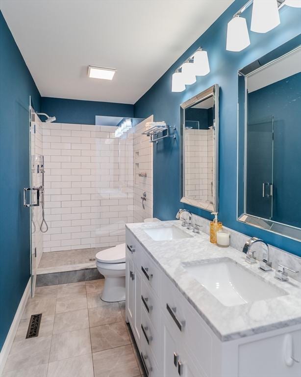 bathroom with toilet, visible vents, a sink, and a stall shower
