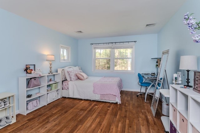 bedroom with visible vents and hardwood / wood-style flooring