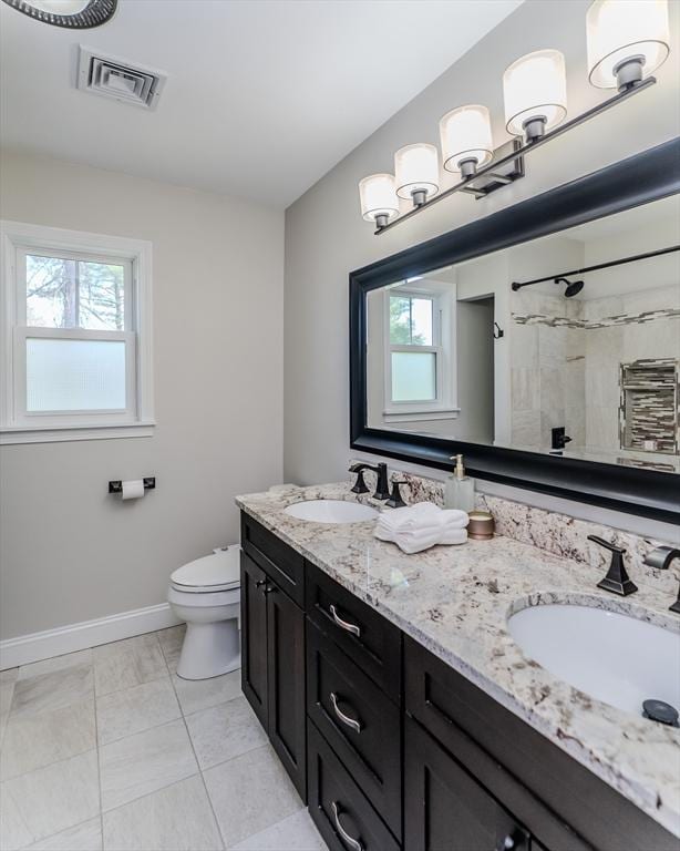 bathroom with a sink, plenty of natural light, and visible vents