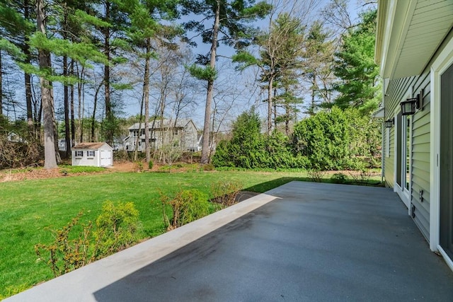 view of patio featuring an outdoor structure and a storage shed
