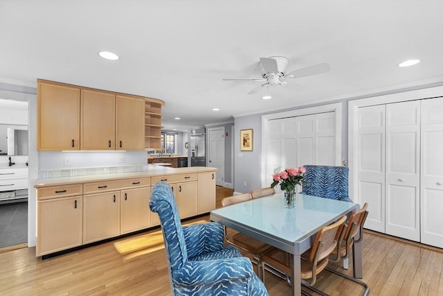 dining space featuring crown molding, ceiling fan, and light hardwood / wood-style floors