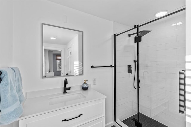 bathroom with vanity and a shower with door