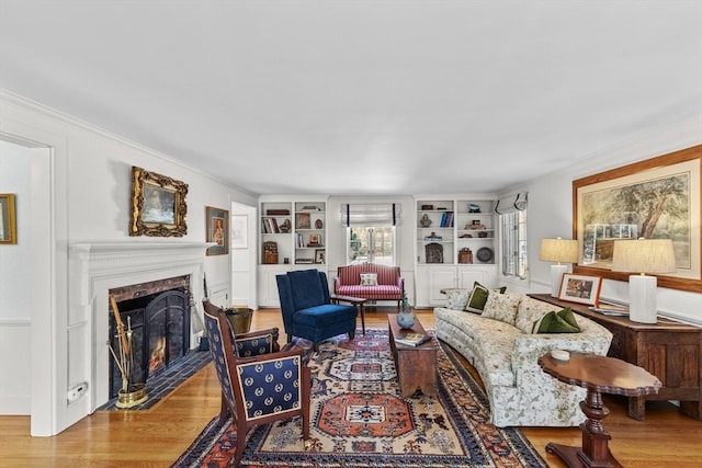 living room featuring wood-type flooring and built in features