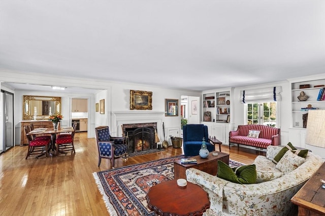 living room featuring hardwood / wood-style flooring and built in shelves