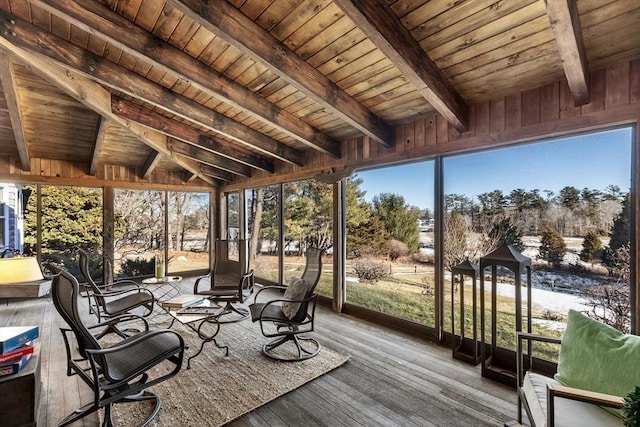 unfurnished sunroom featuring beamed ceiling and wooden ceiling