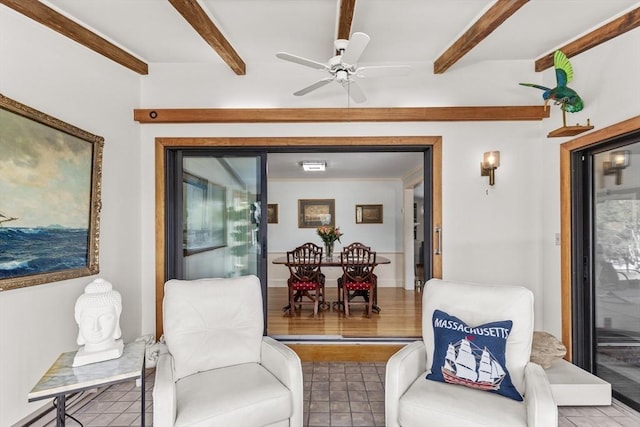 interior space with ceiling fan and beam ceiling