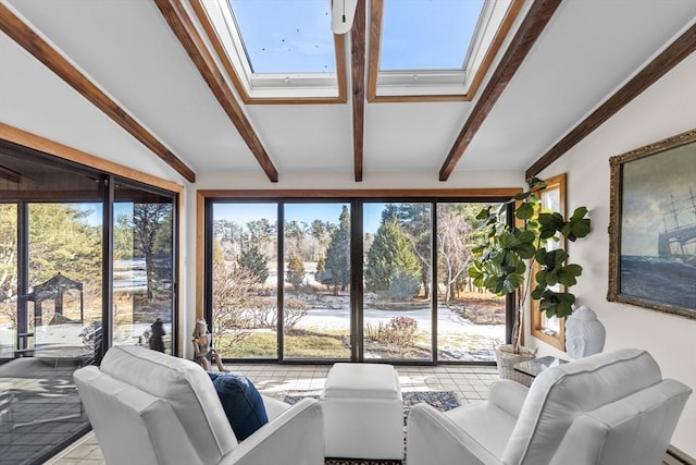 sunroom / solarium featuring lofted ceiling with skylight