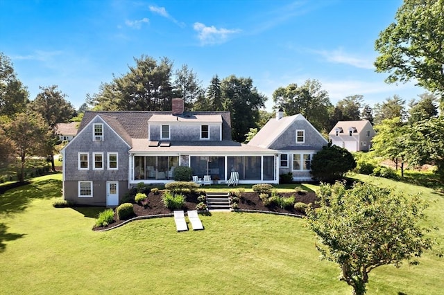 back of property featuring a lawn and a sunroom