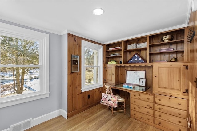 office featuring built in desk and light hardwood / wood-style flooring