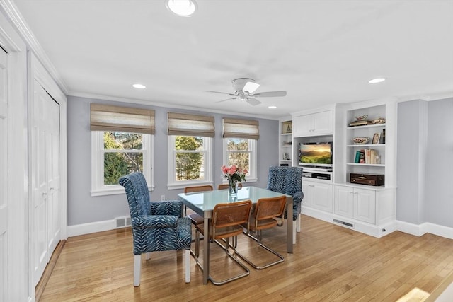 dining space with ornamental molding, a healthy amount of sunlight, ceiling fan, and light hardwood / wood-style flooring