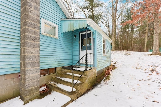 view of snow covered property entrance