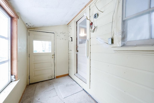 entryway featuring vaulted ceiling