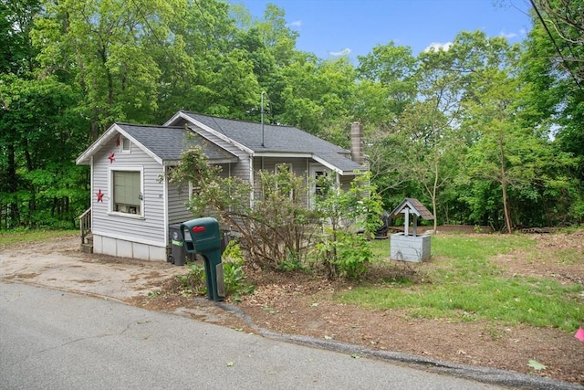 32 Powder House Ave, Haverhill, MA 01830 - view of front of house featuring roof with shingles and a chimney