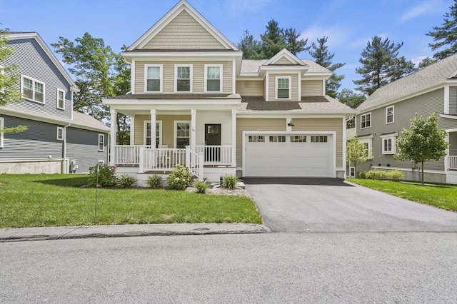 view of front of property featuring a garage, aphalt driveway, a front lawn, and a porch