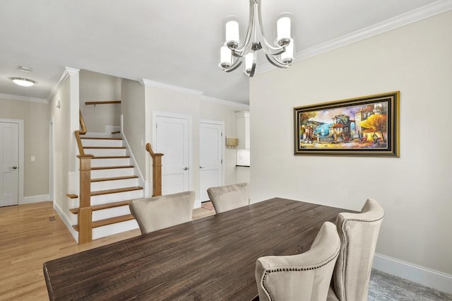 dining room featuring light wood finished floors, baseboards, stairs, crown molding, and a notable chandelier