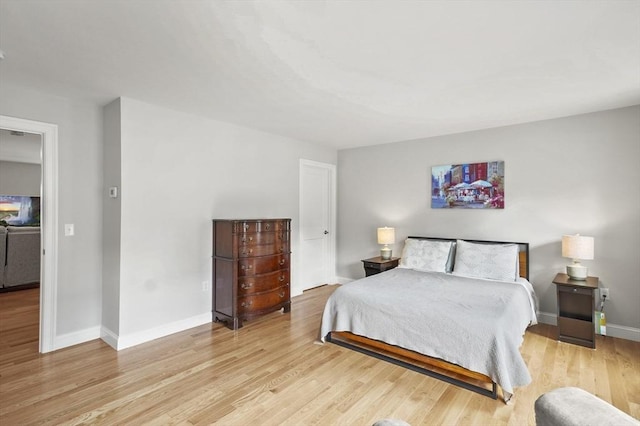 bedroom featuring baseboards and light wood-style floors