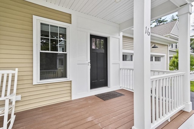 wooden terrace featuring a garage