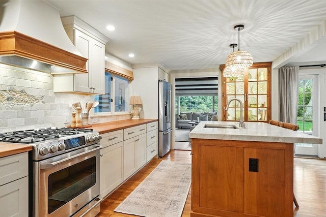 22 Partridge Rd, Duxbury, MA 02332 - kitchen featuring appliances with stainless steel finishes, premium range hood, a sink, plenty of natural light, and recessed lighting