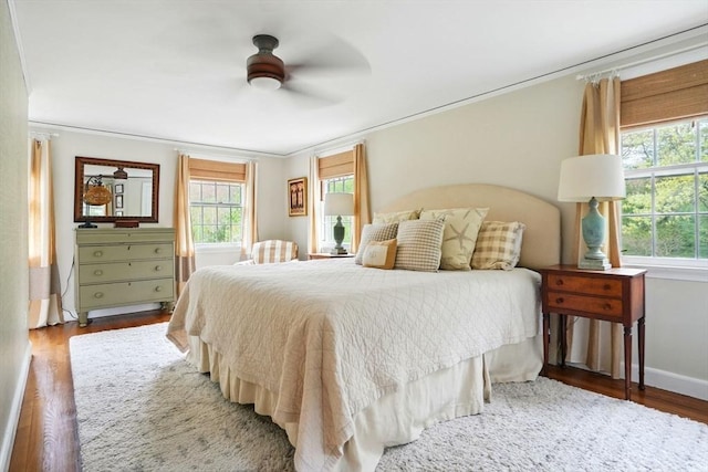 22 Partridge Rd, Duxbury, MA 02332 - bedroom with multiple windows, crown molding, wood finished floors, baseboards, and ceiling fan