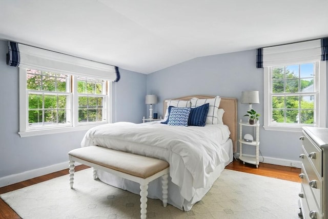 22 Partridge Rd, Duxbury, MA 02332 - bedroom with vaulted ceiling, multiple windows, baseboards, and wood finished floors