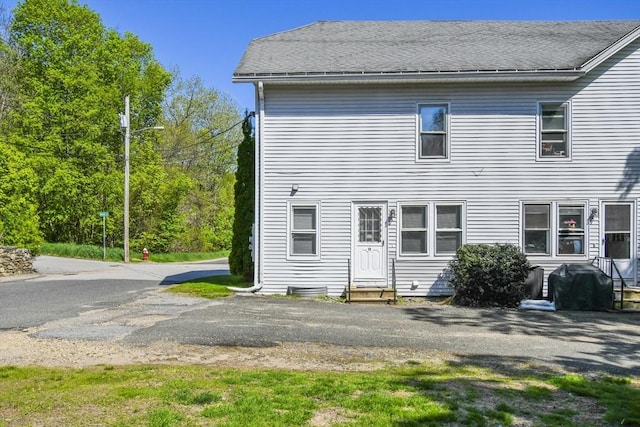 11 Broad St Unit 11, Hardwick, MA 01005 - back of property featuring entry steps and roof with shingles