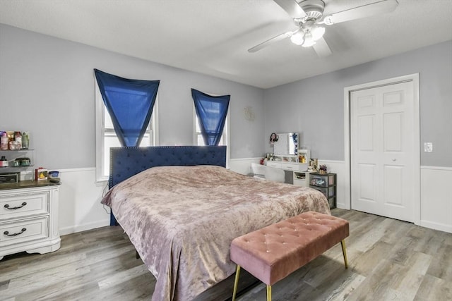 11 Broad St Unit 11, Hardwick, MA 01005 - bedroom with light wood-type flooring, a wainscoted wall, and a ceiling fan