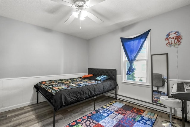 11 Broad St Unit 11, Hardwick, MA 01005 - bedroom with wood finished floors, ceiling fan, a textured ceiling, a wainscoted wall, and a baseboard radiator