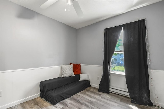 11 Broad St Unit 11, Hardwick, MA 01005 - sitting room with a baseboard radiator, wood finished floors, wainscoting, and ceiling fan
