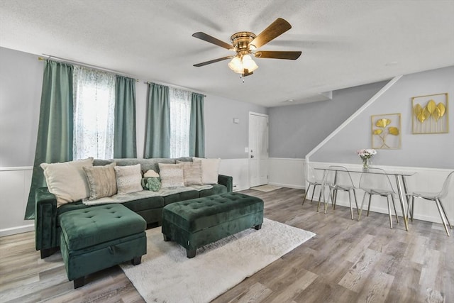 11 Broad St Unit 11, Hardwick, MA 01005 - living area with ceiling fan, wood finished floors, and a textured ceiling