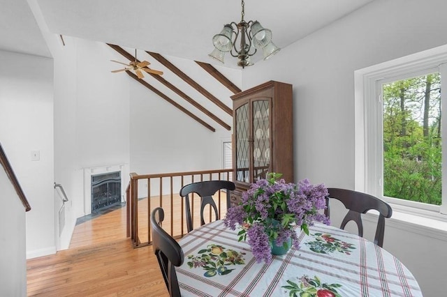 401 Colonial Dr Unit 35, Ipswich, MA 01938 - dining space featuring light wood-style flooring, ceiling fan, a chandelier, a high end fireplace, and high vaulted ceiling
