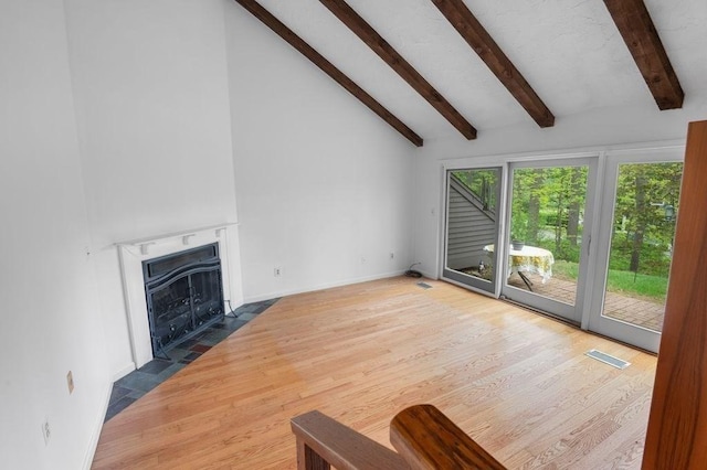 401 Colonial Dr Unit 35, Ipswich, MA 01938 - unfurnished living room with beamed ceiling, wood finished floors, a fireplace with flush hearth, high vaulted ceiling, and baseboards