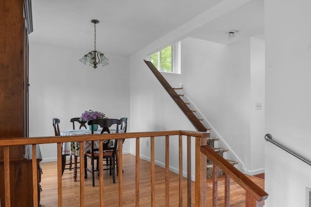 401 Colonial Dr Unit 35, Ipswich, MA 01938 - stairs with wood finished floors, baseboards, and a chandelier