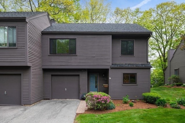 401 Colonial Dr Unit 35, Ipswich, MA 01938 - view of front of home featuring a garage, asphalt driveway, a front lawn, and a shingled roof
