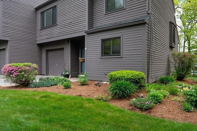 401 Colonial Dr Unit 35, Ipswich, MA 01938 - view of exterior entry featuring a garage and a lawn