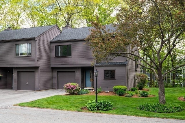 401 Colonial Dr Unit 35, Ipswich, MA 01938 - view of front of house featuring a garage, driveway, a chimney, a shingled roof, and a front lawn