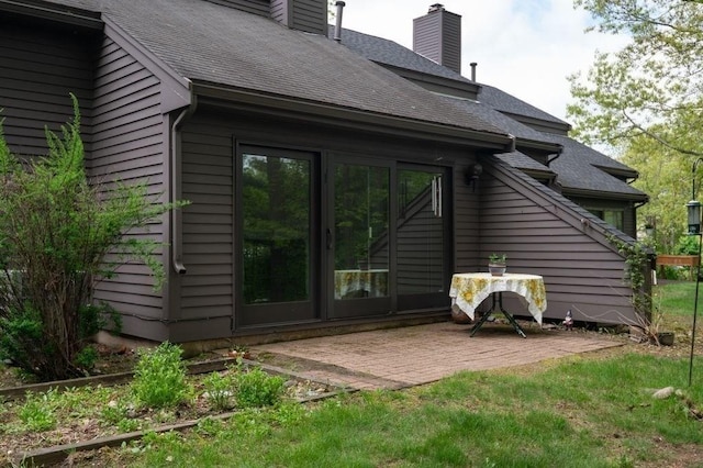 401 Colonial Dr Unit 35, Ipswich, MA 01938 - back of house featuring a patio area, a chimney, and a shingled roof