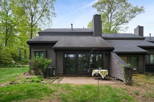 401 Colonial Dr Unit 35, Ipswich, MA 01938 - back of house featuring a patio, a yard, central air condition unit, a chimney, and french doors