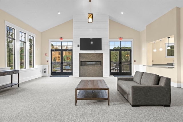 living room with carpet flooring, french doors, and high vaulted ceiling